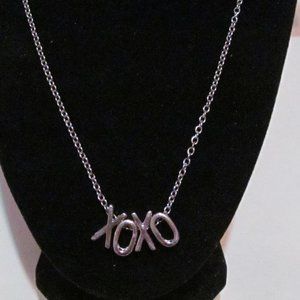 Woman's silver tone xoxo necklace